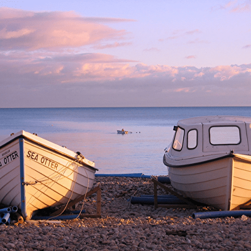 two boats on the sand at the beach